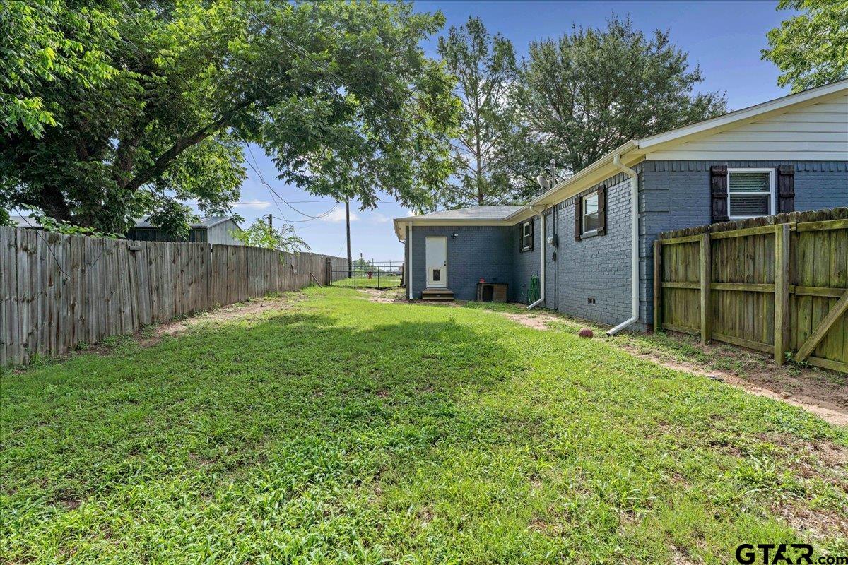 403 Kennedy Street Lindale, TX 75771 - Photo 29 of 36 a view of a backyard with a garden