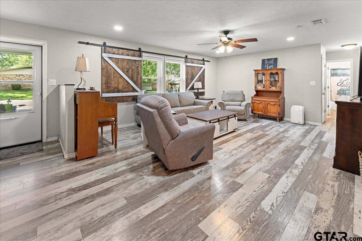 403 Kennedy Street Lindale, TX 75771 - Photo 3 of 36 a living room with furniture and wooden floor