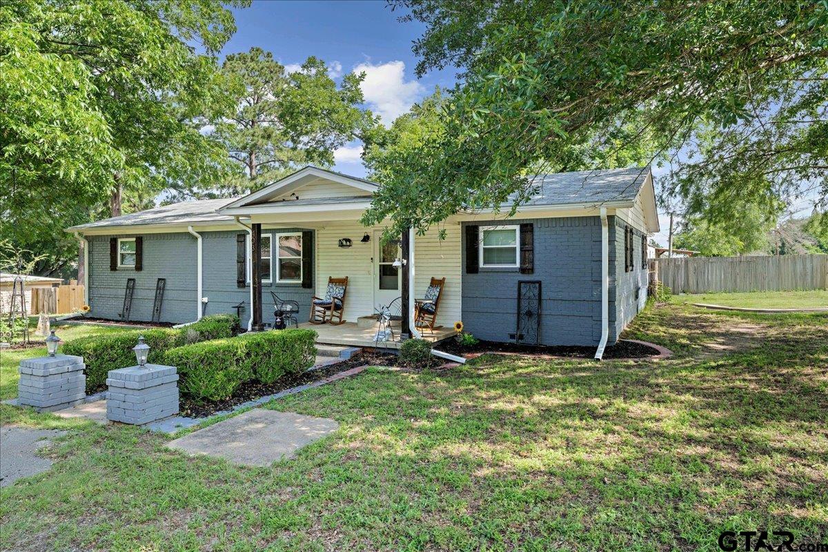 403 Kennedy Street Lindale, TX 75771 - Photo 31 of 36 a view of a house with backyard sitting area and garden