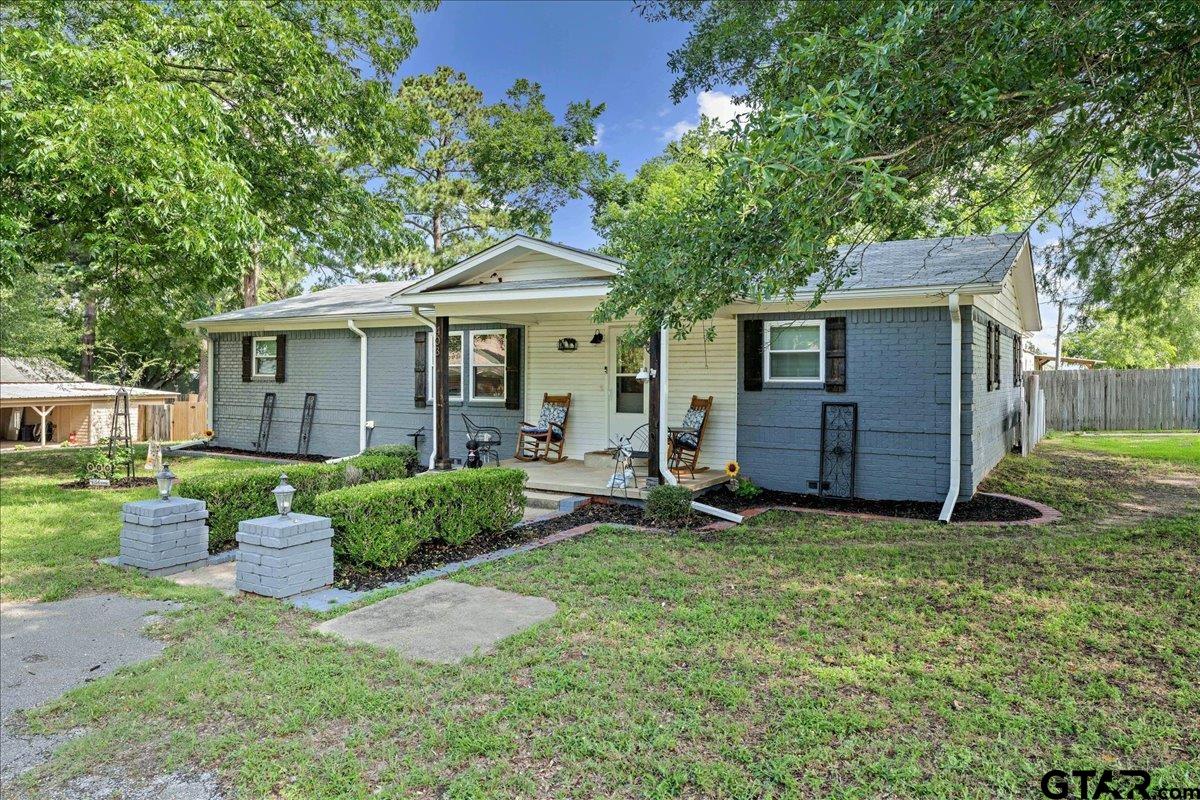 403 Kennedy Street Lindale, TX 75771 - Photo 32 of 36 a view of a house with a yard and potted plants