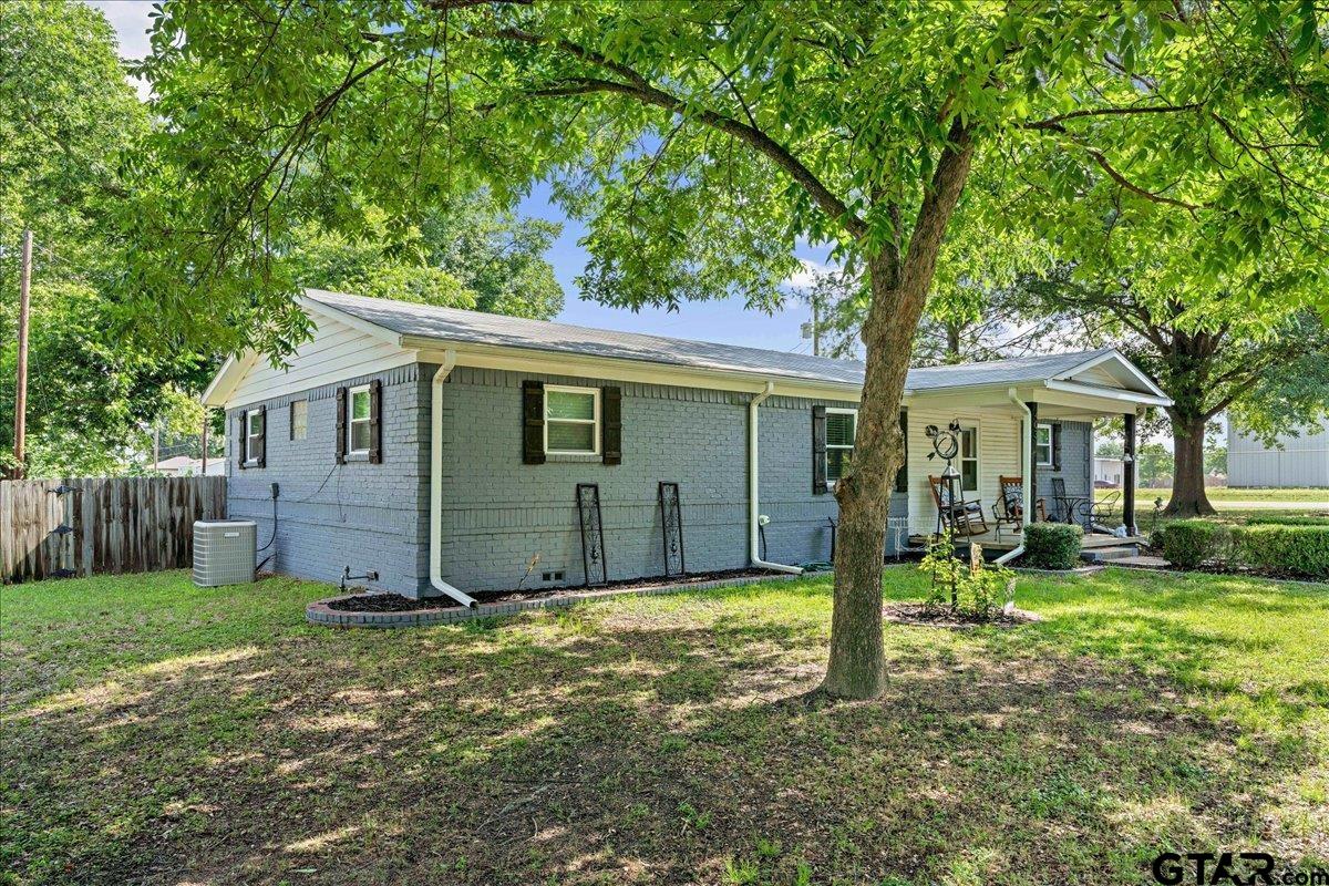 403 Kennedy Street Lindale, TX 75771 - Photo 35 of 36 a view of a house with backyard and a tree