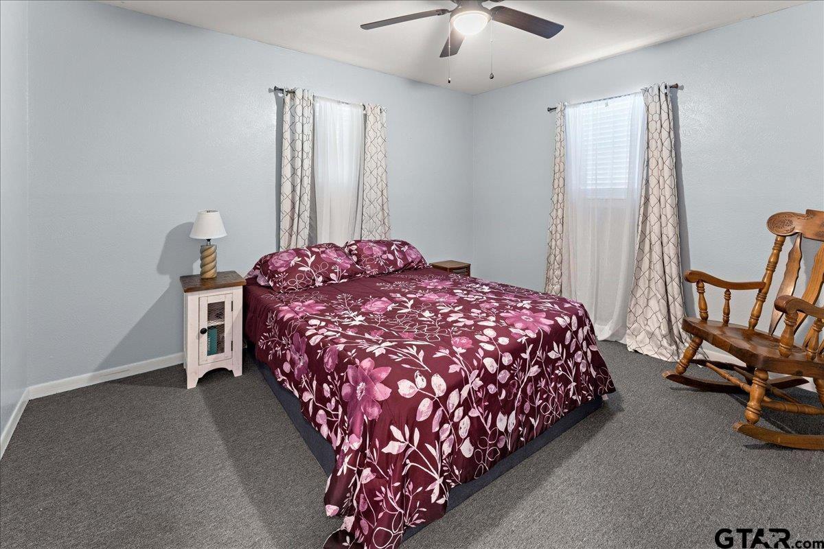 403 Kennedy Street Lindale, TX 75771 - Photo 5 of 36 a bedroom with a bed and a chandelier