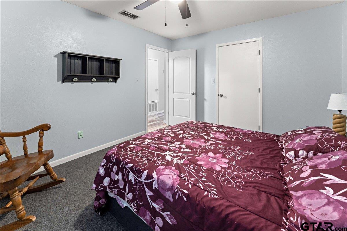 403 Kennedy Street Lindale, TX 75771 - Photo 6 of 36 a bedroom with a bed and a tv