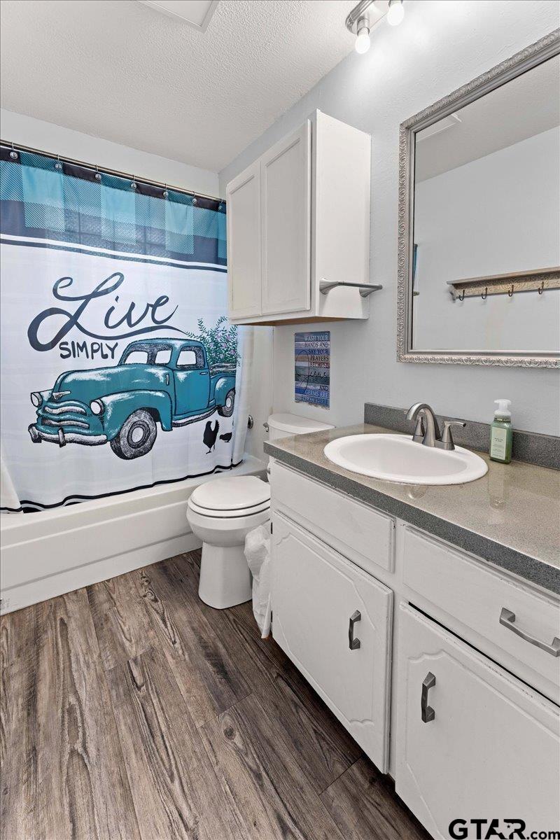 403 Kennedy Street Lindale, TX 75771 - Photo 8 of 36 a bathroom with a toilet sink and mirror