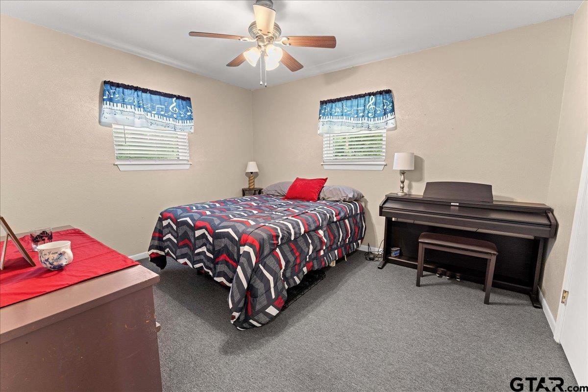 403 Kennedy Street Lindale, TX 75771 - Photo 9 of 36 a bedroom with a bed and a chandelier
