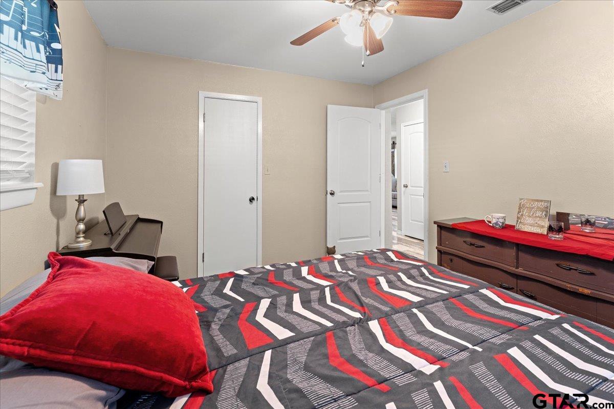403 Kennedy Street Lindale, TX 75771 - Photo 10 of 36 a bedroom with bed and a chandelier