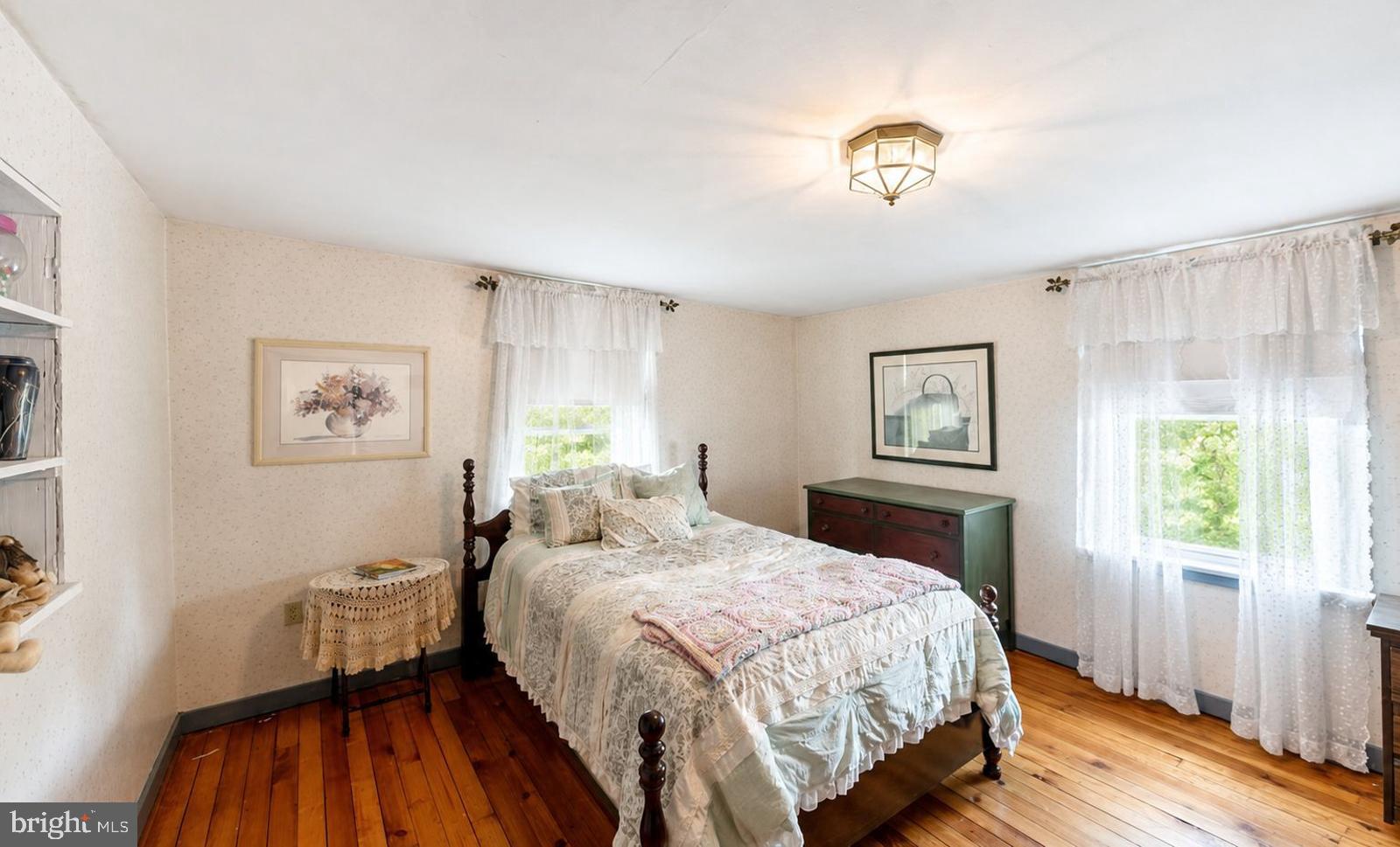 222 Blue School Road Perkasie, PA 18944 - Photo 35 of 77 a bedroom with a bed and a chandelier