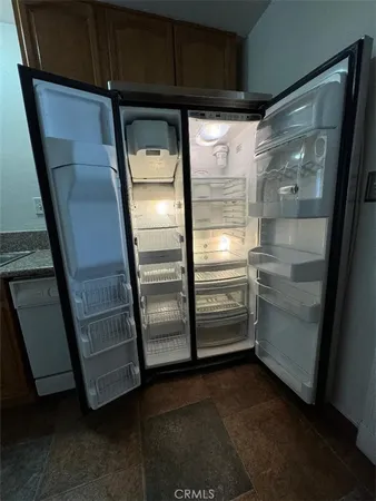 a refrigerator freezer and a dishwasher sitting inside of a kitchen