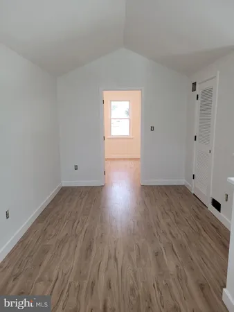 a view of a room with wooden floor and window