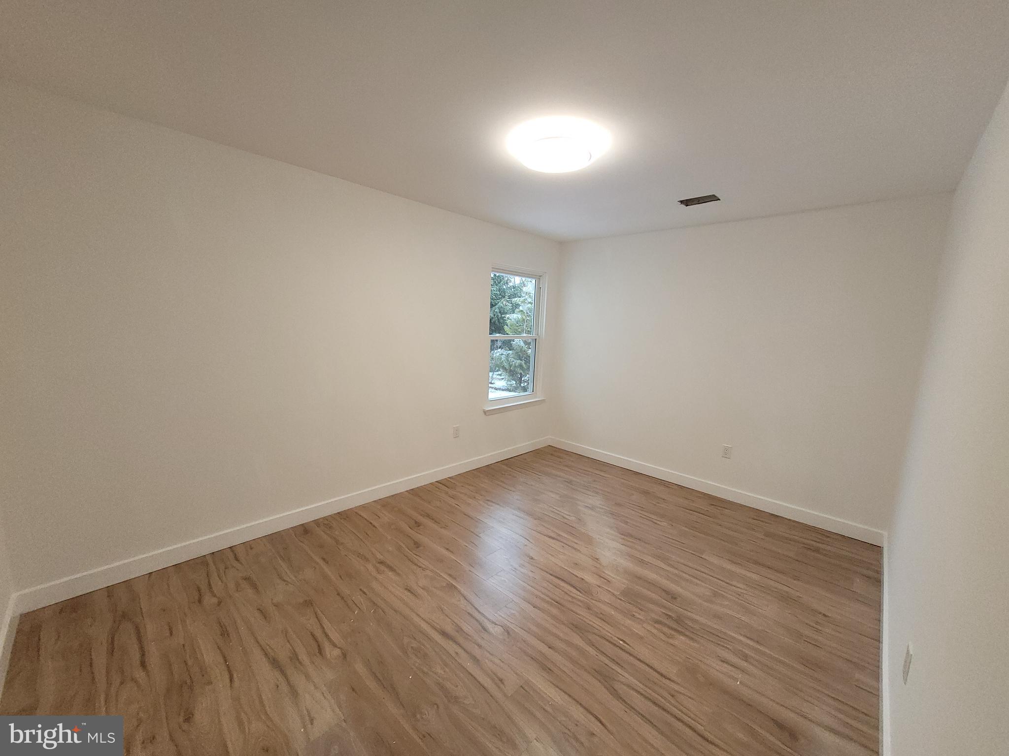 4 Stewer Lane Perkasie, PA 18944 - Photo 7 of 18 an empty room with wooden floor and windows
