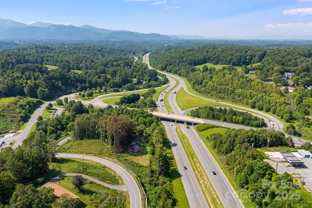 a view of a lush green field with outside view
