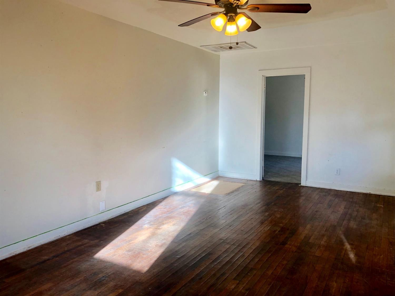 2612 27th Street Lubbock, TX 79410 - Photo 2 of 6 a view of an empty room and wooden floor