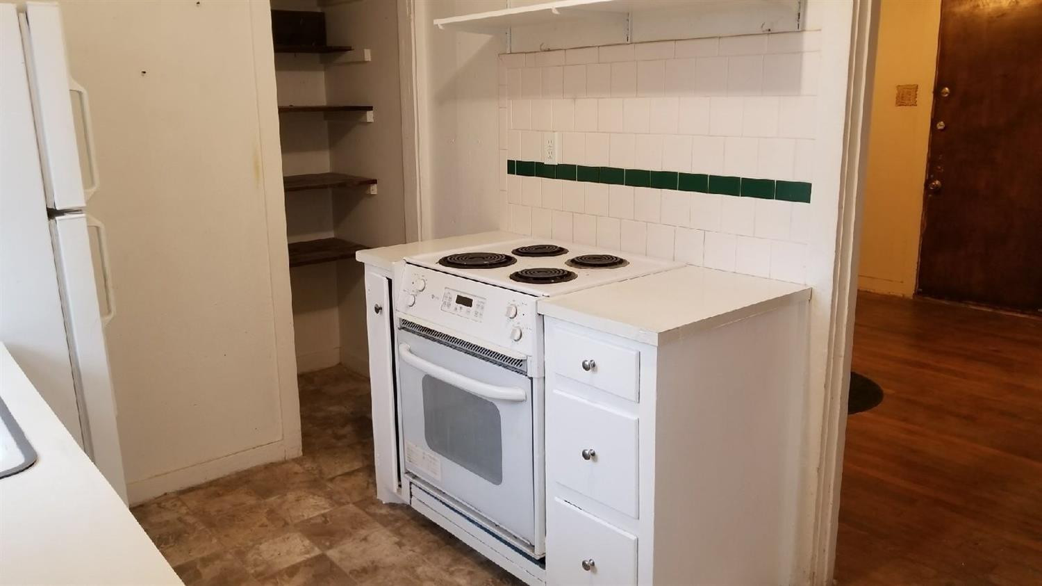 2612 27th Street Lubbock, TX 79410 - Photo 3 of 6 a kitchen with a stove and a white cabinet