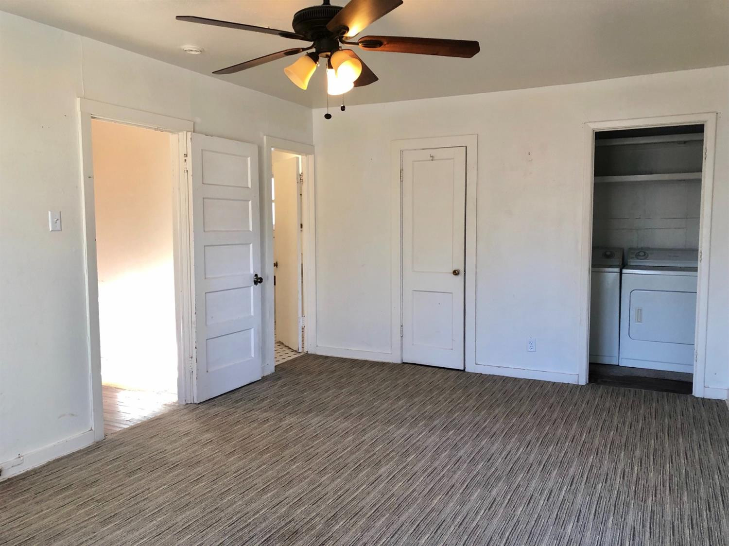 2612 27th Street Lubbock, TX 79410 - Photo 5 of 6 an empty room with wooden floor a ceiling fan and entryway