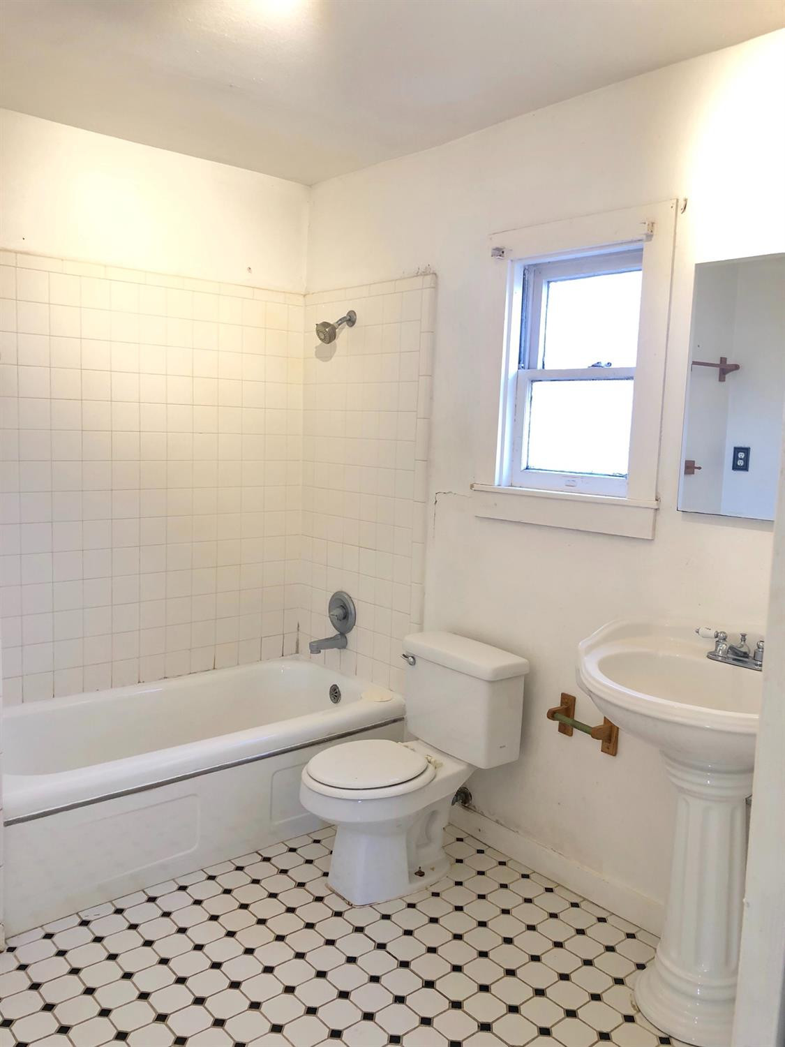 2612 27th Street Lubbock, TX 79410 - Photo 6 of 6 a bathroom with a toilet a sink and a bathtub