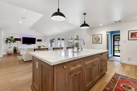 a kitchen with stainless steel appliances granite countertop a stove and a sink