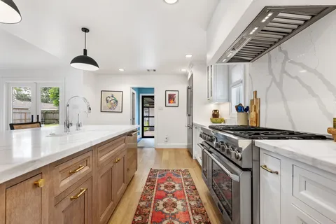 a kitchen with a sink and a stove top oven