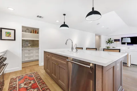 an entryway with wooden floor and a cabinet