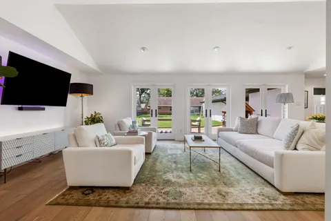 a living room with fireplace furniture and a flat screen tv