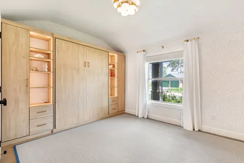 a living room with furniture a table and a large window