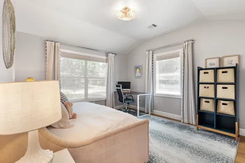 a bedroom with a bed and wooden floor