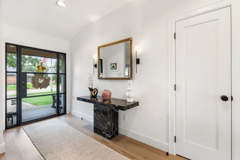 a view of a hallway to a livingroom and a window