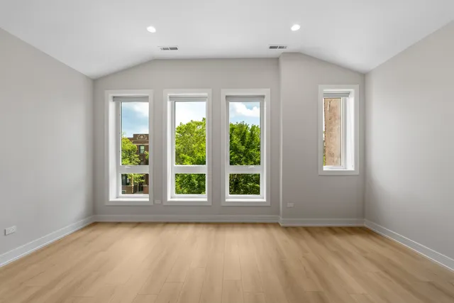 a view of a hallway with wooden floor and stairs