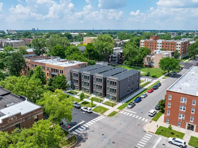 an aerial view of a house with a garden and lake view