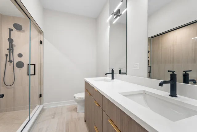 a bathroom with a double vanity sink and mirror