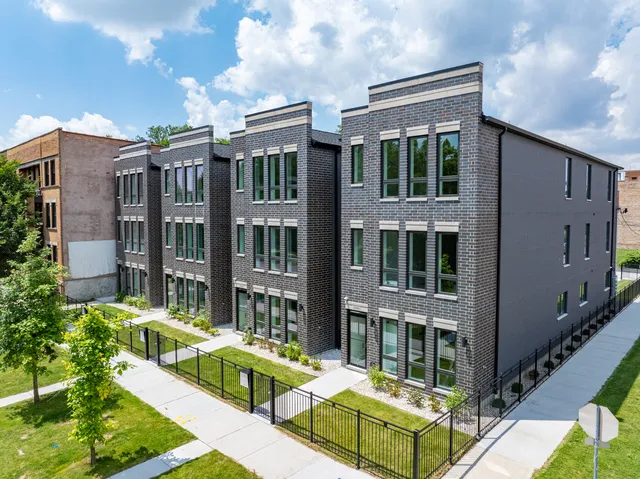 a front view of a residential apartment building with a yard