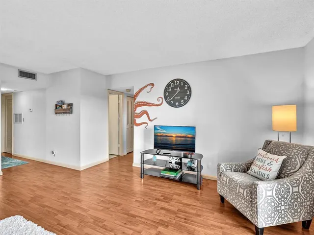 a bathroom with a granite countertop sink a mirror a bathtub and a toilet