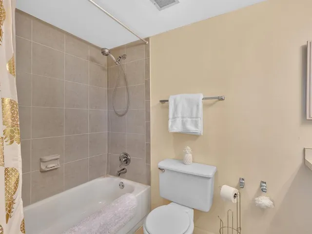 a bed room with a bed and a painting on the wall