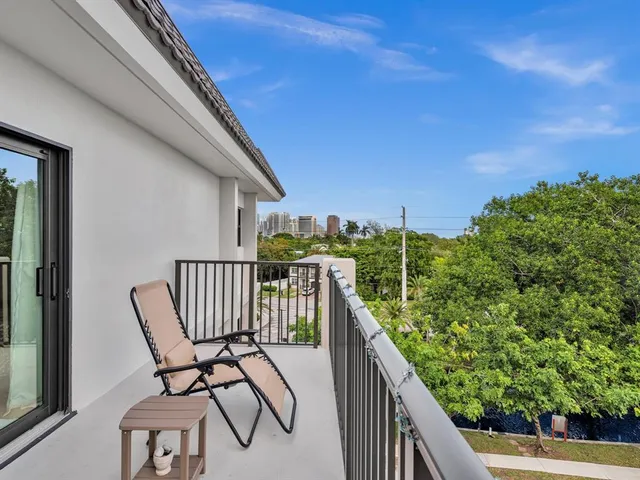 a view of cars parked on the side of a street