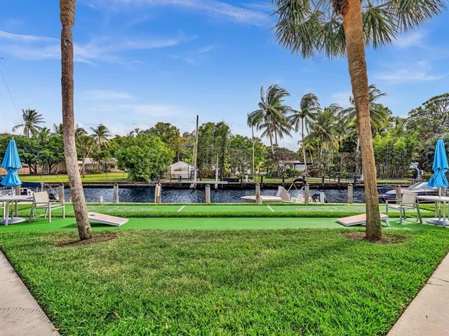 a view of a patio with a table and chairs and potted plants