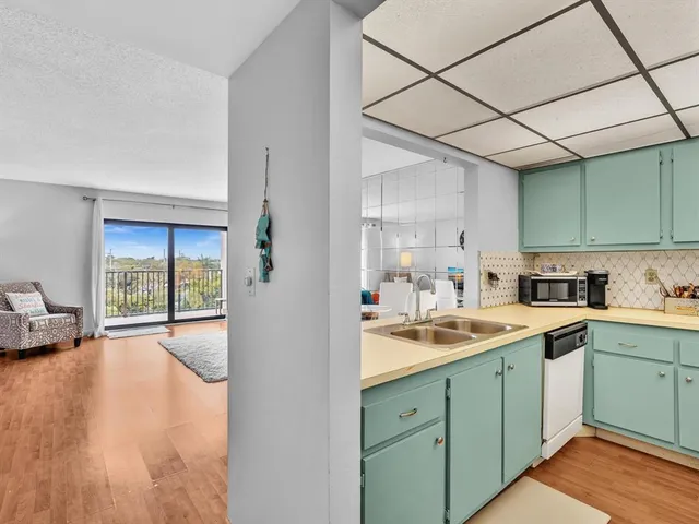 a kitchen with a sink cabinets and window