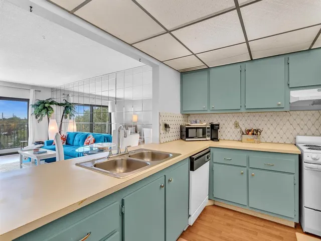a view of a kitchen with cabinets and a wooden floor