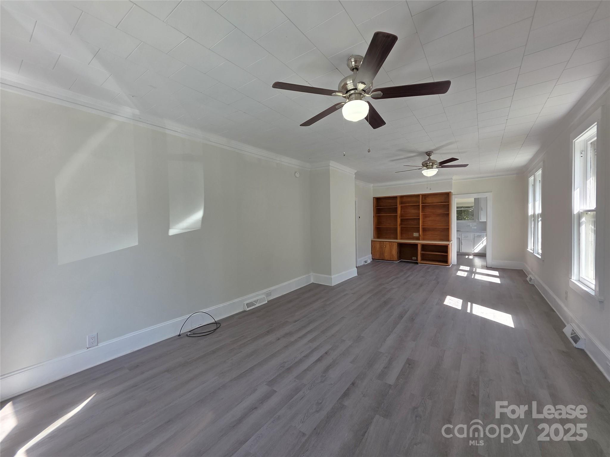 106 Falls Road Badin, NC 28009 - Photo 4 of 19 a view of empty room with wooden floor and window