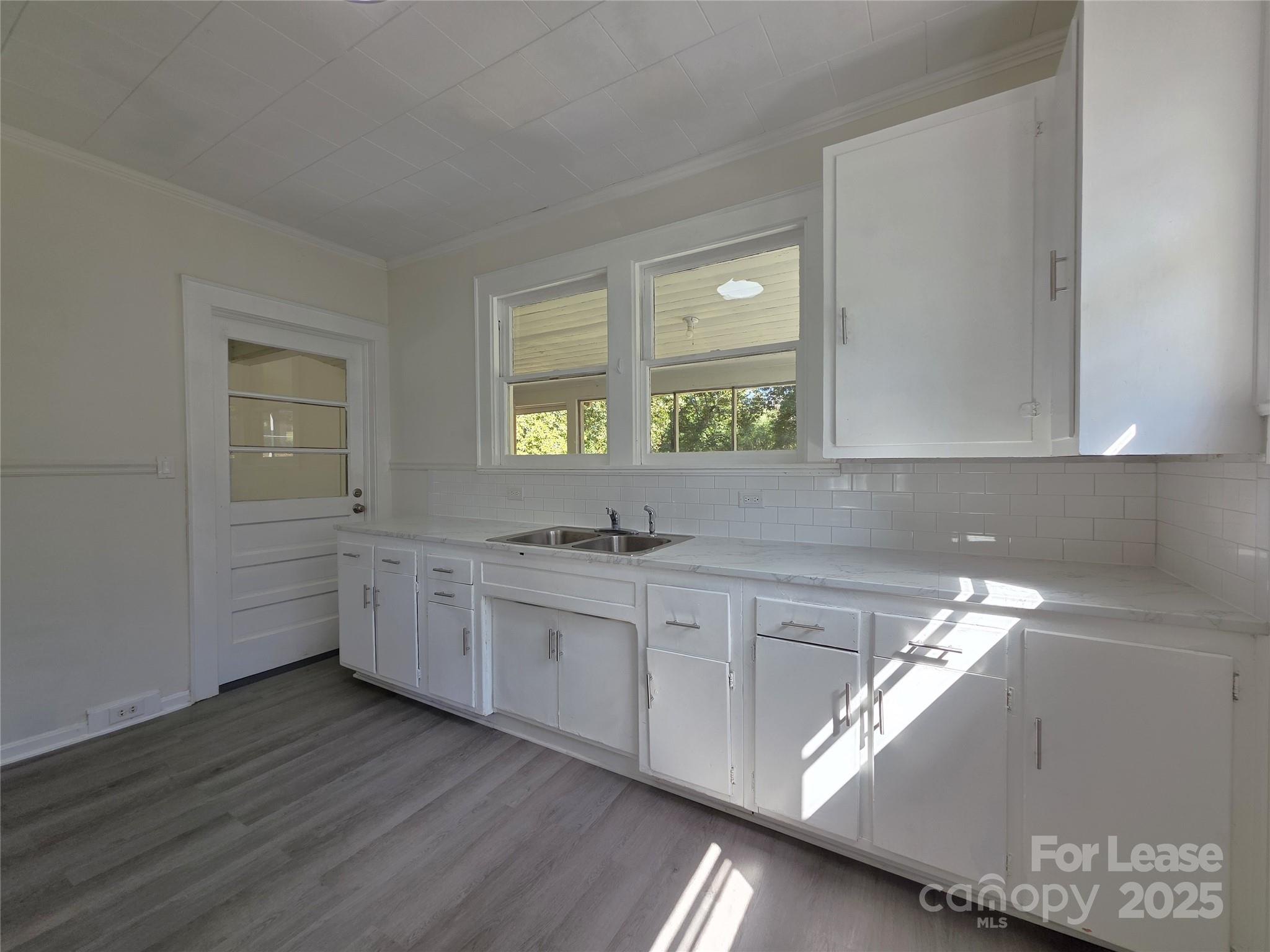 106 Falls Road Badin, NC 28009 - Photo 6 of 19 a kitchen with a sink cabinets and window