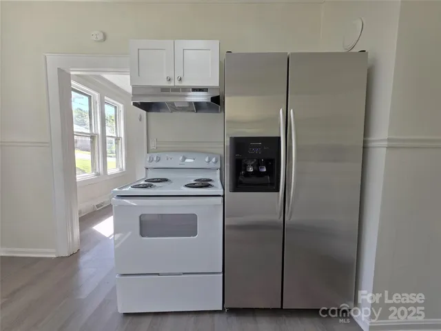 a kitchen with cabinets and steel stainless steel appliances