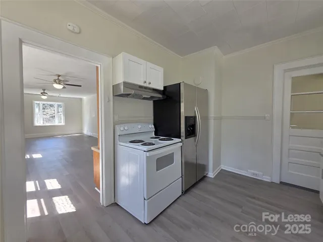 a kitchen with a stove and a refrigerator