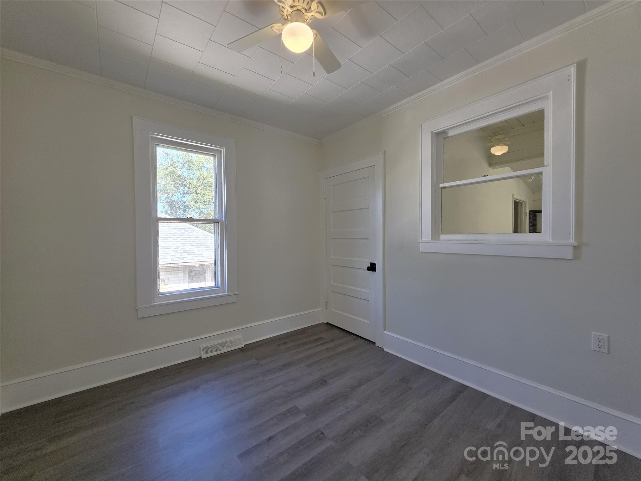 106 Falls Road Badin, NC 28009 - Photo 9 of 19 an empty room with wooden floor and windows
