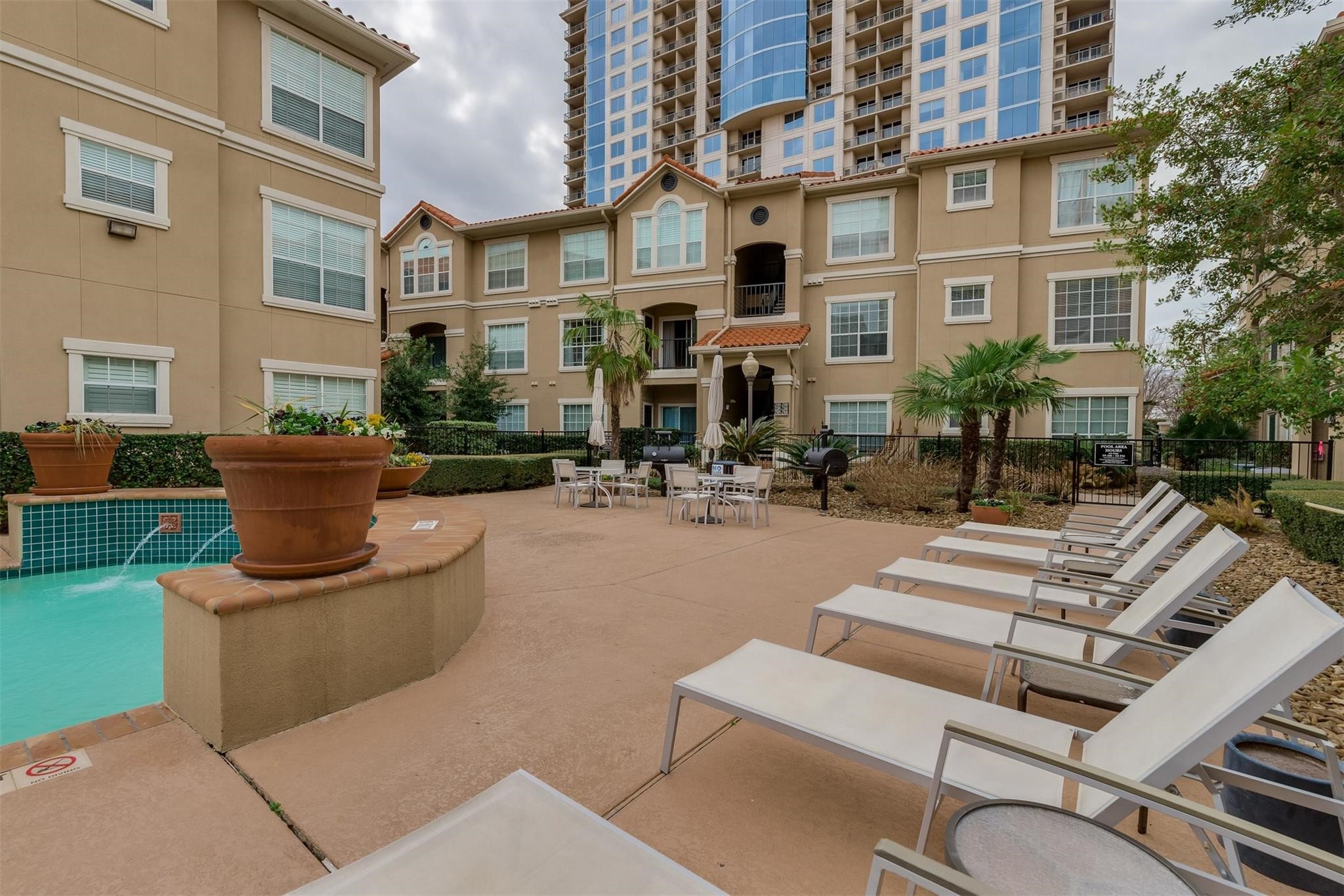 This complex is designed for both entertaining and relaxation, with expansive common areas, outdoor grills, plush lounge chairs, and a beautiful resort-style pool.