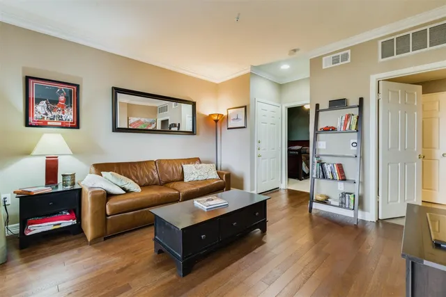 a living room with furniture and a floor to ceiling window
