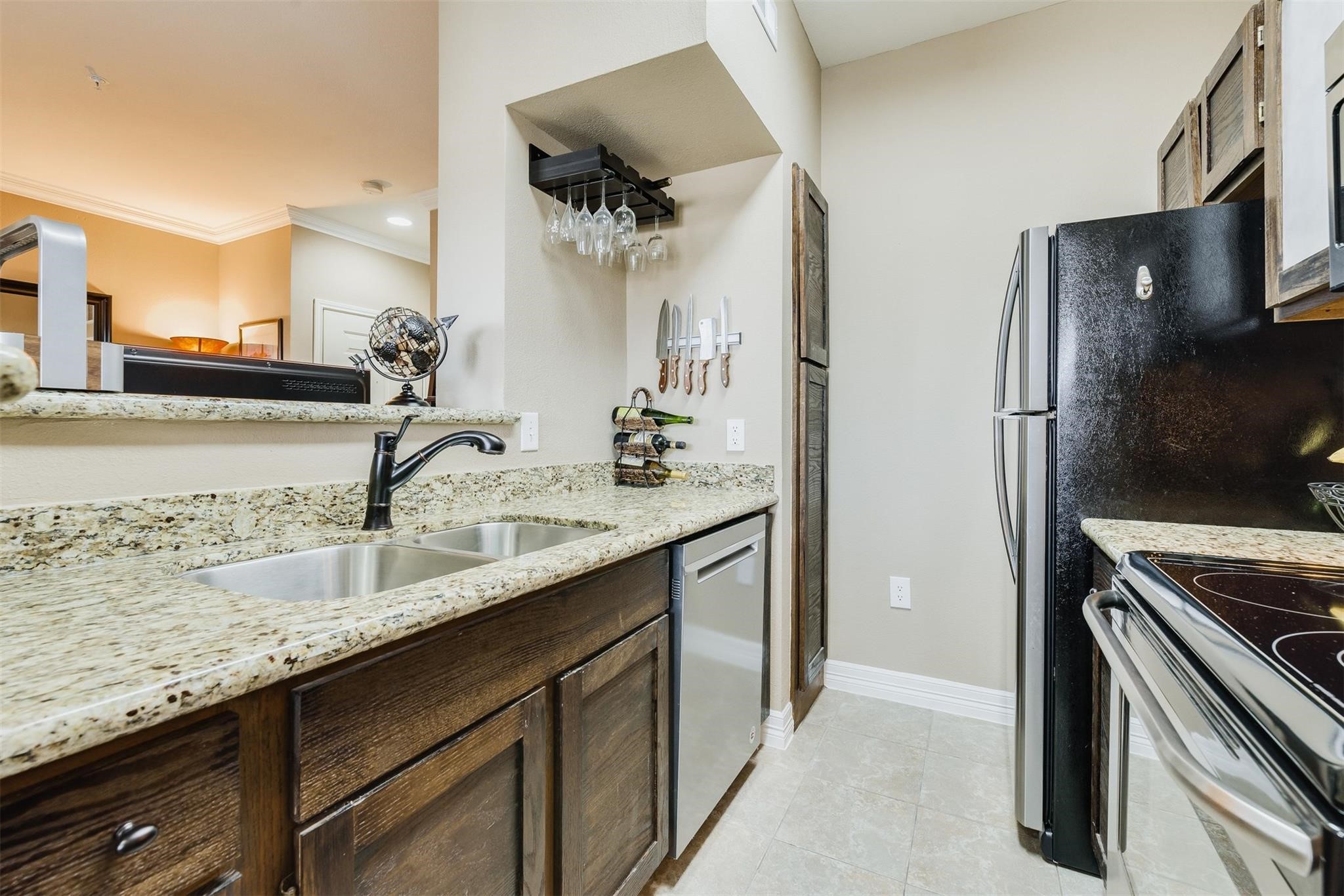 3231 Allen Parkway, Unit 1110 Houston, TX 77019 - Photo 6 of 17 a kitchen with stainless steel appliances granite countertop a sink and a refrigerator