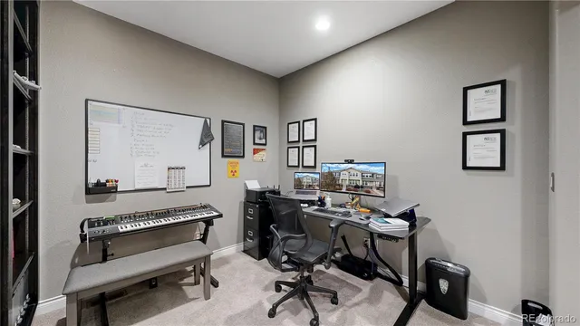 a view of a workspace with furniture and a window