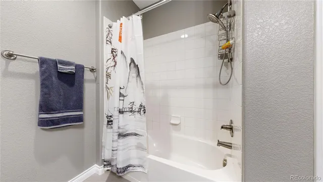 a bathroom with a bathtub and shower