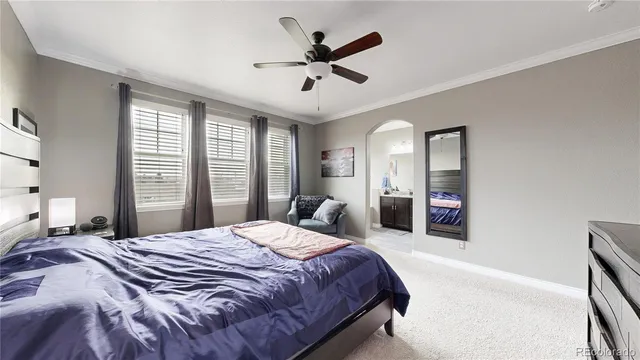 a bedroom with a large bed and a chandelier