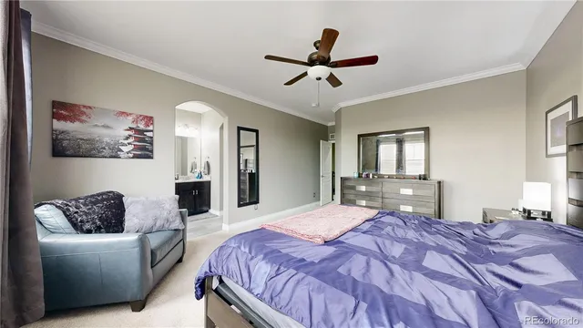 a bedroom with a bed couch and window