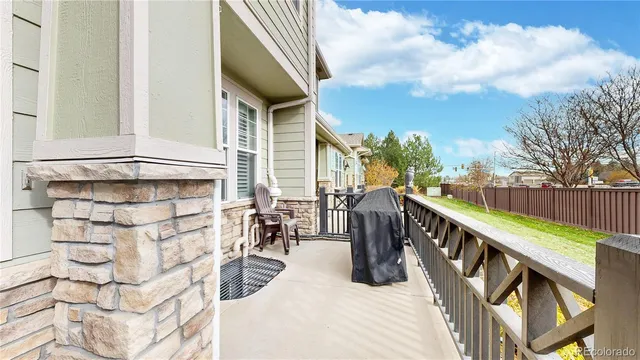 a view of a balcony with wooden chairs