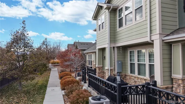 a aerial view of a house with a yard and balcony